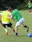 Teenagers playing football in a Raise Your Game session.