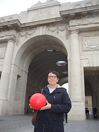 Veronic receiving the Peace Poppy Footballs at Menin Gate, Ypres. to deliver to Ghana.